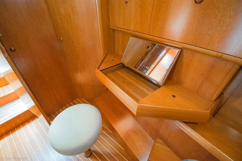 Slide: The Image of A sleek wooden vanity with a mirror and stool in a yacht cabin. - 21