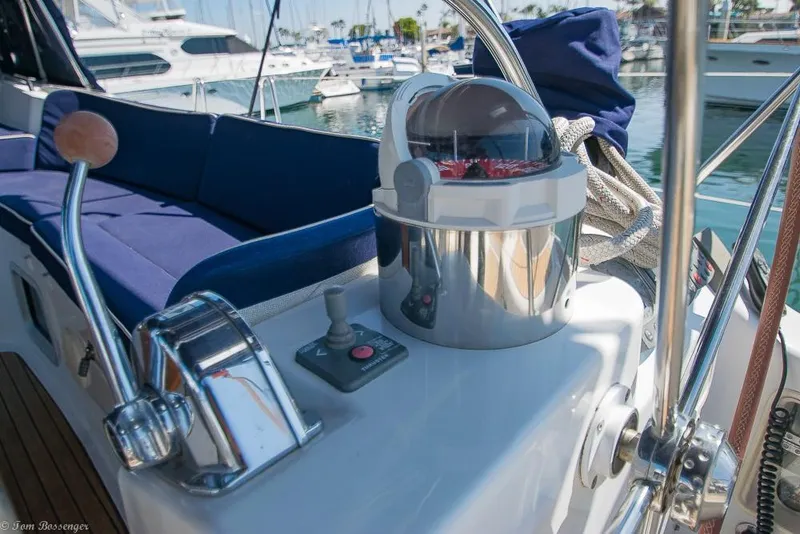 Slide: The Image of The cockpit of a 2006 Jeanneau Sun Odyssey 54 DS with controls and blue seating cushions. - 44