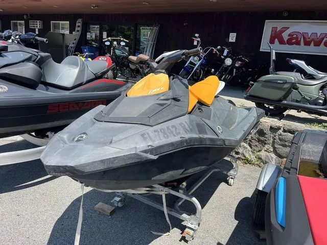 The Image of A gray and orange Sea-Doo jet ski is on a trailer in an outdoor area. - 1