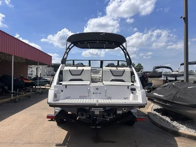 Slide: The Image of 2023 Yamaha 222SE with open deck and black sunshade, parked on a trailer. - 4