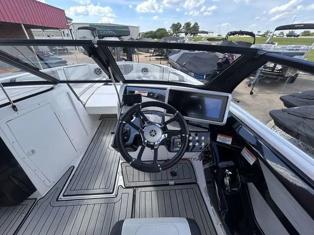 Slide: The Image of The image shows the cockpit of a 2023 Yamaha 222SE boat with modern steering and instruments. - 12