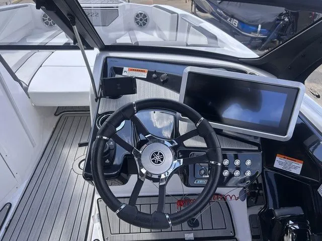 Slide: The Image of The image shows the cockpit of a Yamaha 222SE boat with a modern steering wheel and large display. - 13