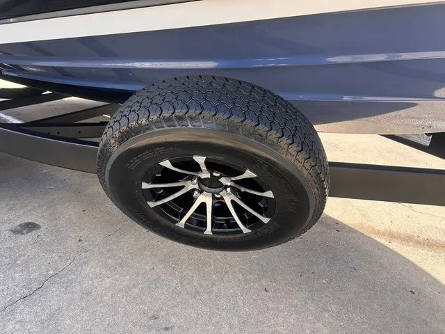 Slide: The Image of Close-up of a boat trailer with a black wheel and silver spokes. - 7