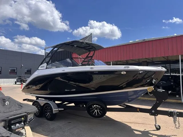 Slide: The Image of A 2023 Yamaha 222SE boat on a trailer in front of a building under a blue sky. - 6