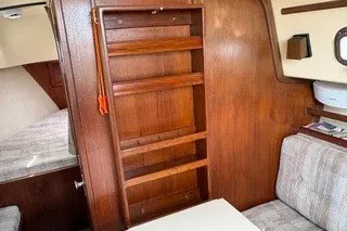 Slide: The Image of 1990 Island Packet 27 interior with wooden cabinetry and cozy seating area. - 38