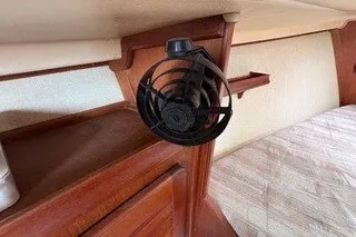 Slide: The Image of 1990 Island Packet 27 interior with wooden cabinetry and mounted fan. - 28