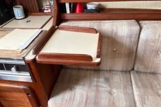 Slide: The Image of 1990 Island Packet 27 interior with foldable table and cushioned seating. - 35