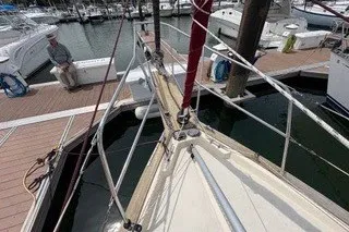 Slide: The Image of 1990 Island Packet 27 sailboat docked at marina with visible rigging and deck. - 10