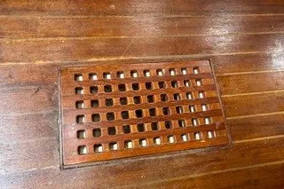 Slide: The Image of Wooden deck with a rectangular vent on a 1990 Island Packet 27 sailboat. - 46