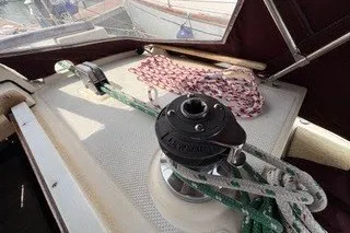 Slide: The Image of 1990 Island Packet 27 sailboat deck with winch and ropes. - 17
