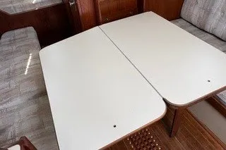 Slide: The Image of 1990 Island Packet 27 interior with foldable dining table and cushioned seating. - 37