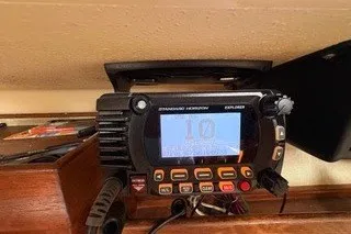 Slide: The Image of VHF radio equipment on a 1990 Island Packet 27 sailboat, featuring a Standard Horizon Explorer. - 30