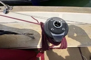 Slide: The Image of Winch on 1990 Island Packet 27 sailboat deck with coiled rope. - 55