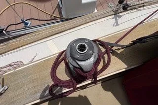 Slide: The Image of Winch on 1990 Island Packet 27 sailboat deck with coiled rope. - 59