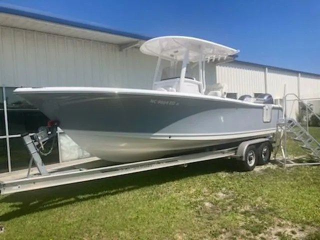 The Image of A 2016 Sea Hunt Gamefish 25 on a trailer beside a building. - 1