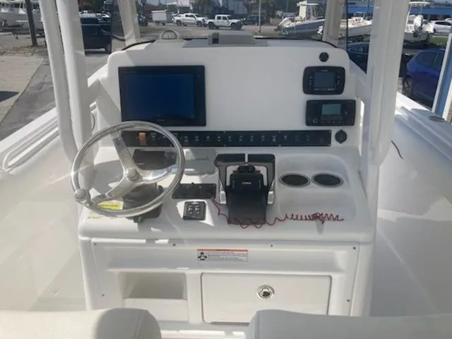 Slide: The Image of The image shows the helm of a 2016 Sea Hunt Gamefish 25 boat with steering wheel and electronics. - 8