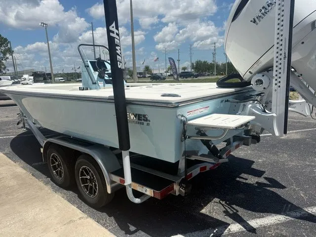 Slide: The Image of A 2027 Hewes Redfisher 21 boat on a trailer in a parking lot. - 6