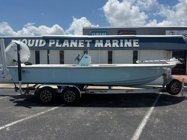 Slide: The Image of 2027 Hewes Redfisher 21 on a trailer in front of a marine store. - 3