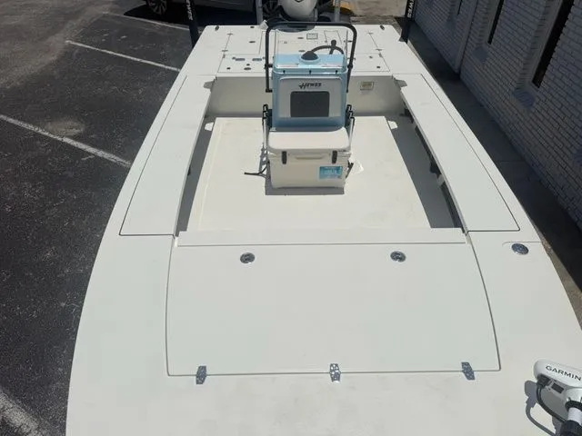 Slide: The Image of The image shows a 2027 Hewes Redfisher 21 boat in a parking lot. - 15