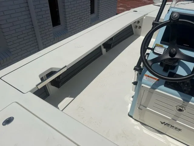 Slide: The Image of The image shows the cockpit of a Hewes Redfisher 21 boat with a steering console. - 10