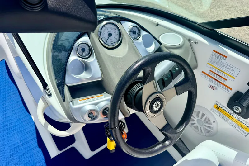 Slide: The Image of 2004 Bombardier SEADOO Utopia 185 dashboard with steering wheel and gauges. - 21
