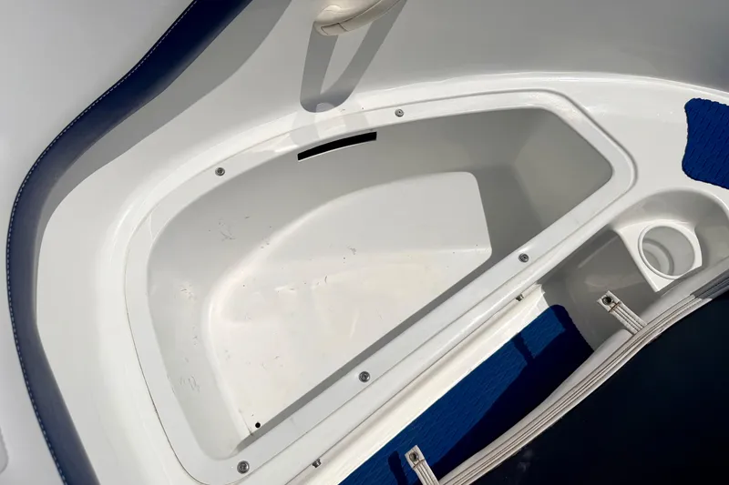 Slide: The Image of Storage compartment of a 2004 Bombardier SEADOO Utopia 185 boat, featuring white and blue interior. - 36