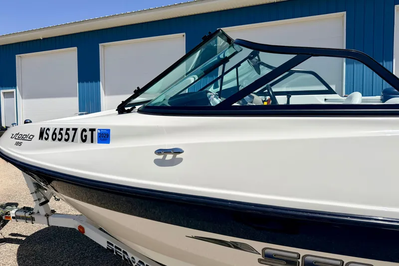 Slide: The Image of 2004 Bombardier SEADOO Utopia 185 boat parked near blue building. - 47