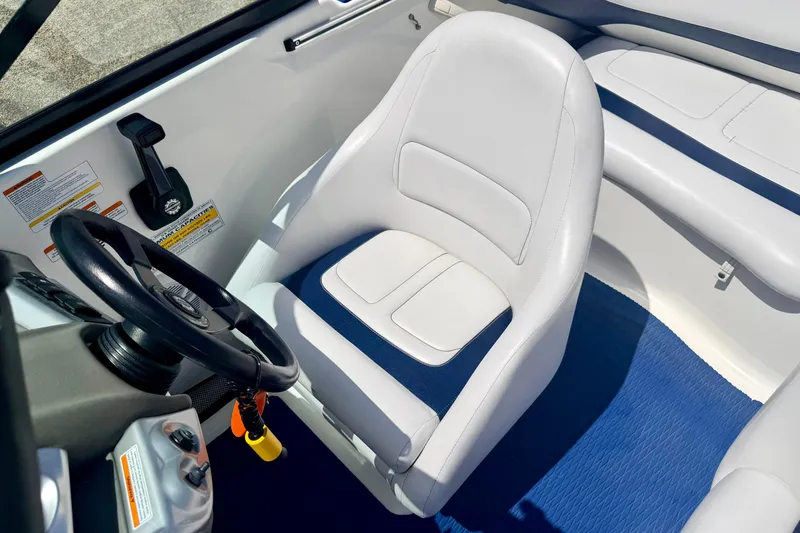 Slide: The Image of Interior of a 2004 Bombardier SEADOO Utopia 185 boat with white seating and steering wheel. - 20