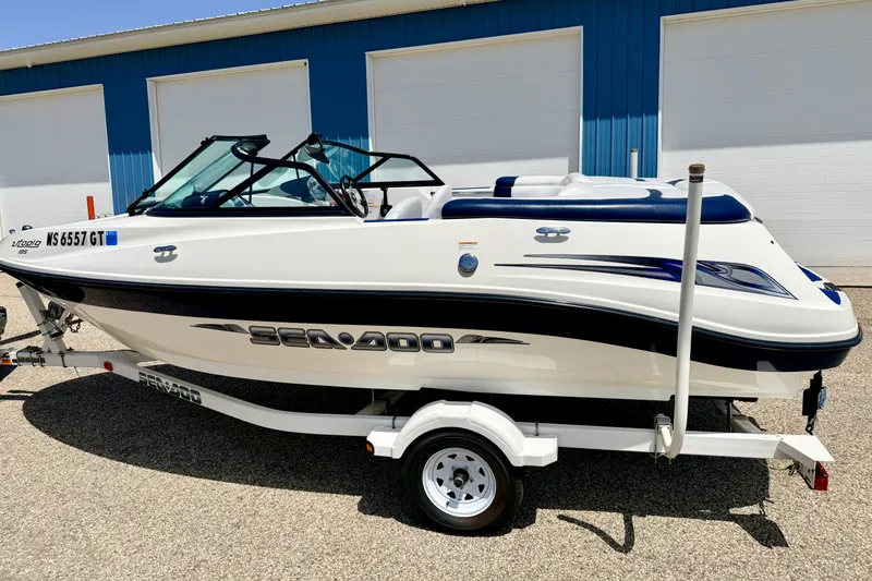 Slide: The Image of 2004 Bombardier SEADOO Utopia 185 boat on trailer, parked outdoors. - 6