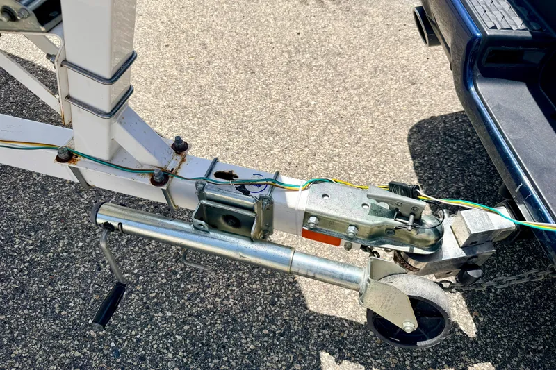 Slide: The Image of Trailer hitch and wiring for 2004 Bombardier SEADOO Utopia 185 on asphalt surface. - 52
