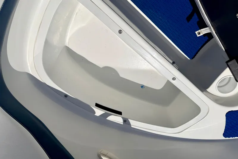 Slide: The Image of 2004 Bombardier SEADOO Utopia 185 boat interior storage compartment, white and blue design. - 38