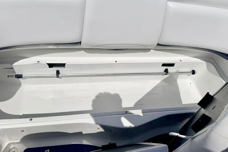 Slide: The Image of 2004 Bombardier SEADOO Utopia 185 storage compartment with white interior and hydraulic support rod. - 19
