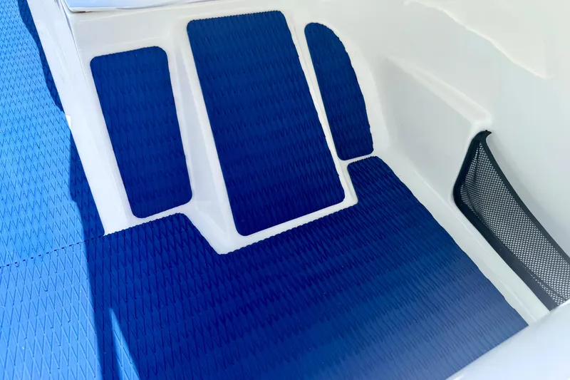 Slide: The Image of Interior view of a 2004 Bombardier SEADOO Utopia 185 with blue non-slip flooring. - 24