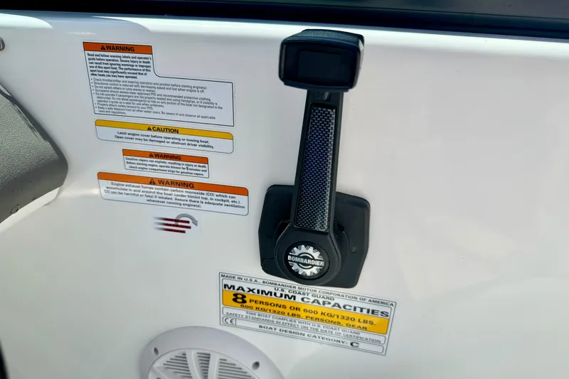 Slide: The Image of 2004 Bombardier SEADOO Utopia 185 warning labels and capacity information on boat interior. - 22