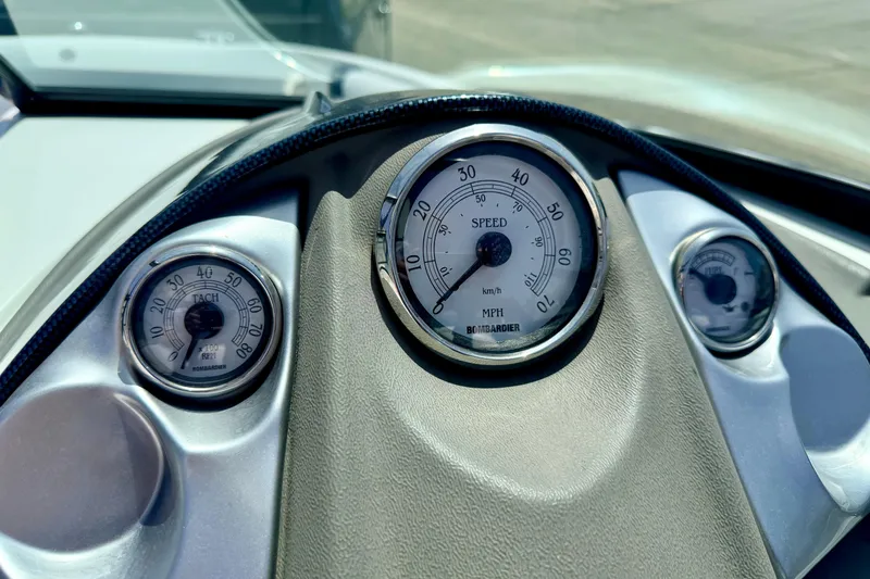 Slide: The Image of Dashboard of a 2004 Bombardier SEADOO Utopia 185, featuring speedometer and tachometer gauges. - 23