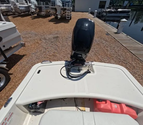 Slide: The Image of The image shows a Mako Pro Skiff 15 CC boat with an outboard motor at a dock. - 22