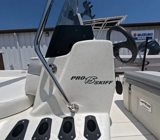 Slide: The Image of Close-up of a Mako Pro Skiff 15 CC console with a Suzuki engine in the background. - 10