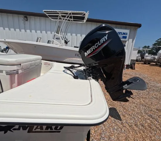 Slide: The Image of A 2023 Mako Pro Skiff 15 CC with a Mercury outboard motor, parked on a gravel lot. - 9