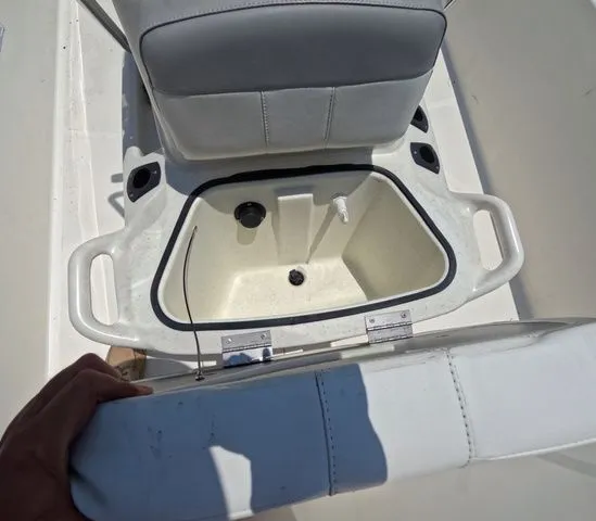 Slide: The Image of An open storage compartment on a Mako Pro Skiff 15 CC boat. - 18