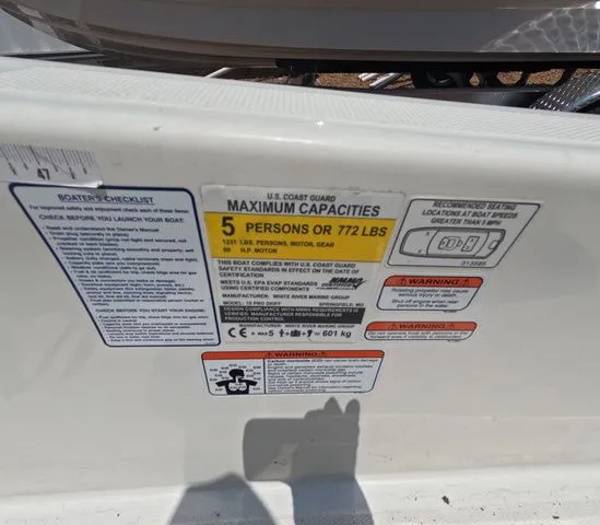Slide: The Image of Label on a boat with capacity and warning information. - 14