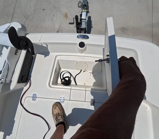 Slide: The Image of A person opens a hatch on a Mako Pro Skiff 15 CC boat. - 20