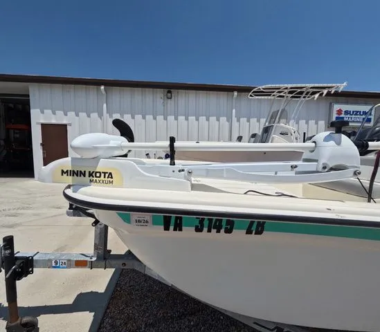 Slide: The Image of A 2023 Mako Pro Skiff 15 CC on a trailer in front of a building. - 12