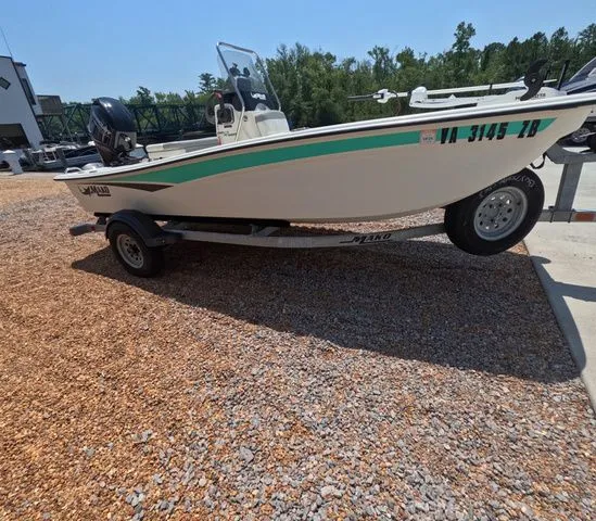 Slide: The Image of A 2023 Mako Pro Skiff 15 CC on a trailer in a gravel area. - 5