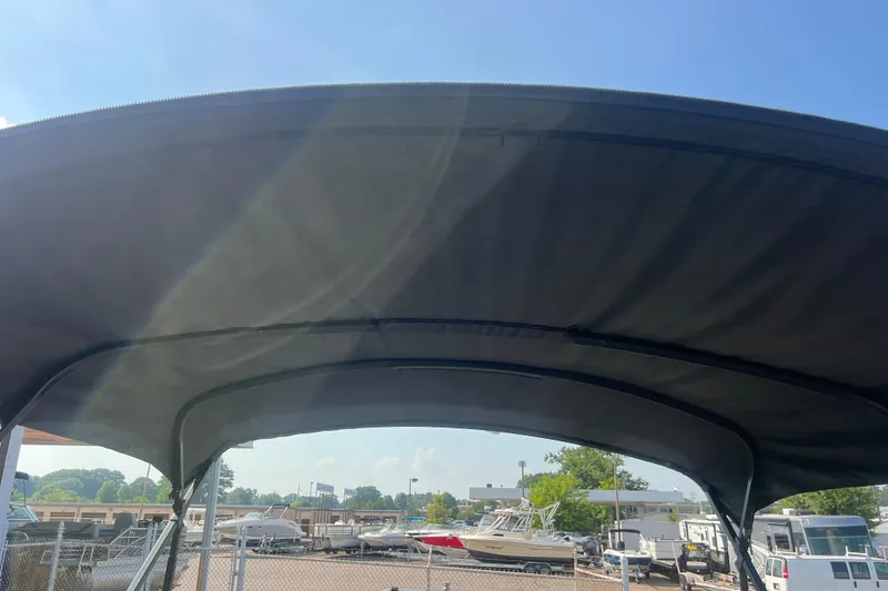 Slide: The Image of Bimini top of 2022 Viaggio Lago V-U 22 boat under clear blue sky. - 42