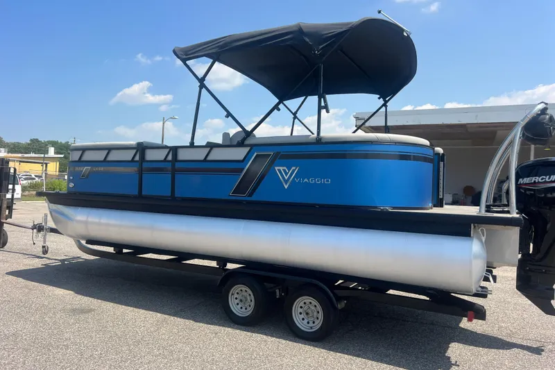 Slide: The Image of 2022 Viaggio Lago V-U 22 pontoon boat with blue exterior on a trailer. - 52