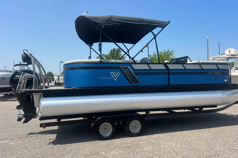 Slide: The Image of 2022 Viaggio Lago V-U 22 pontoon boat with blue exterior on a trailer. - 50