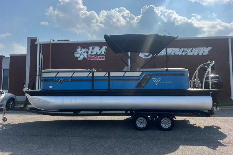 Slide: The Image of 2022 Viaggio Lago V-U 22 pontoon boat on trailer, parked outside HM Boats dealership. - 3