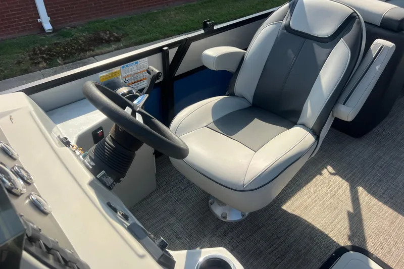 Slide: The Image of Viaggio Lago V-U 22 boat interior, featuring a steering wheel and comfortable captain's chair, 2022 model. - 22