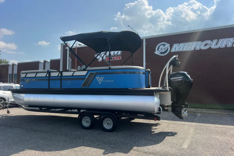 Slide: The Image of 2022 Viaggio Lago V-U 22 pontoon boat with Mercury engine, parked outside dealership. - 4