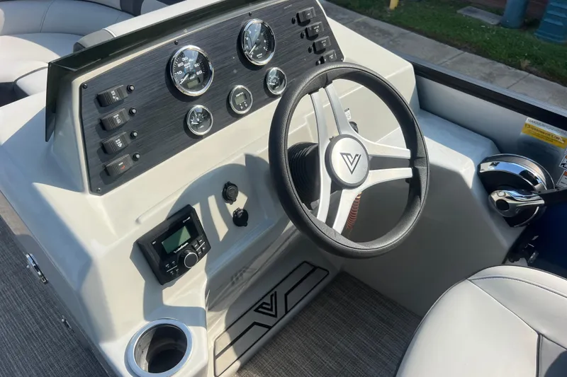 Slide: The Image of 2022 Viaggio Lago V-U 22 boat dashboard with steering wheel and control panel. - 23